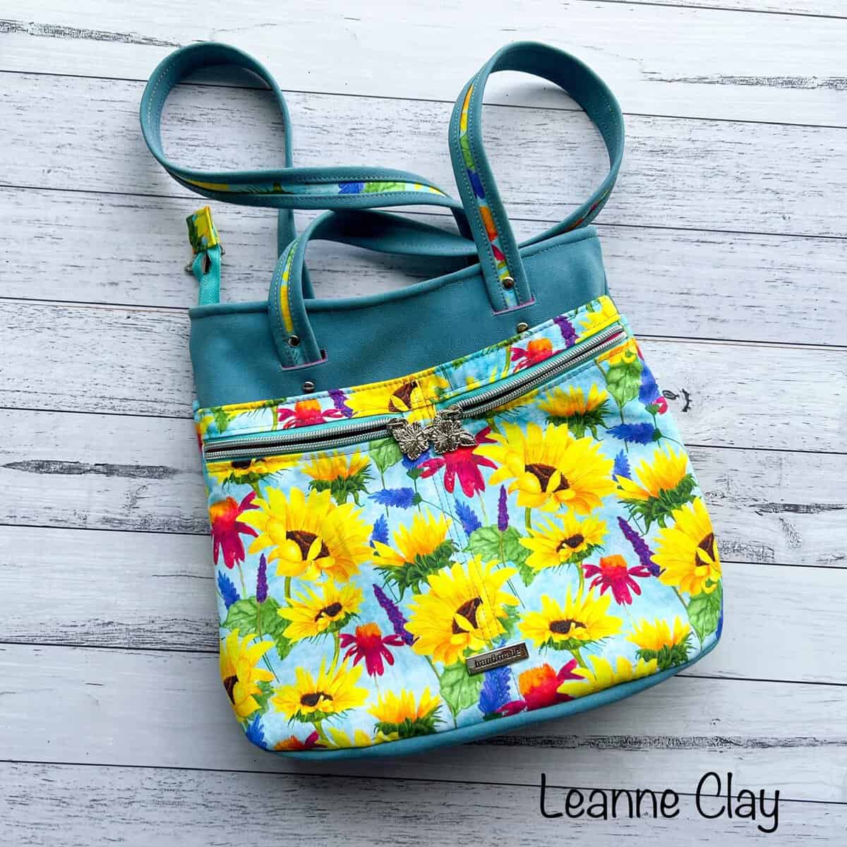 Colorful shopper bag with a sunflower design and zippered compartments.