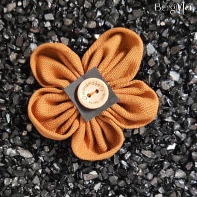 Handgemachte Stoffblume in Orange mit Schleifen-Design.
