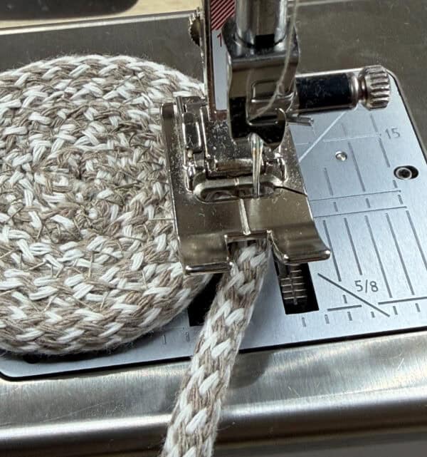 Sewing a rope basket with a sewing machine and thread.