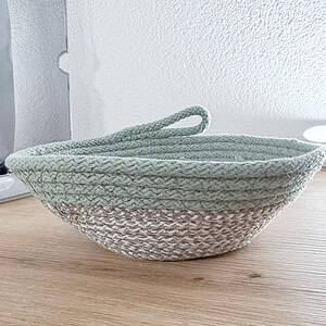 Handgefertigter Seilkorb aus geflochtenem Seil auf Holzoberfläche.